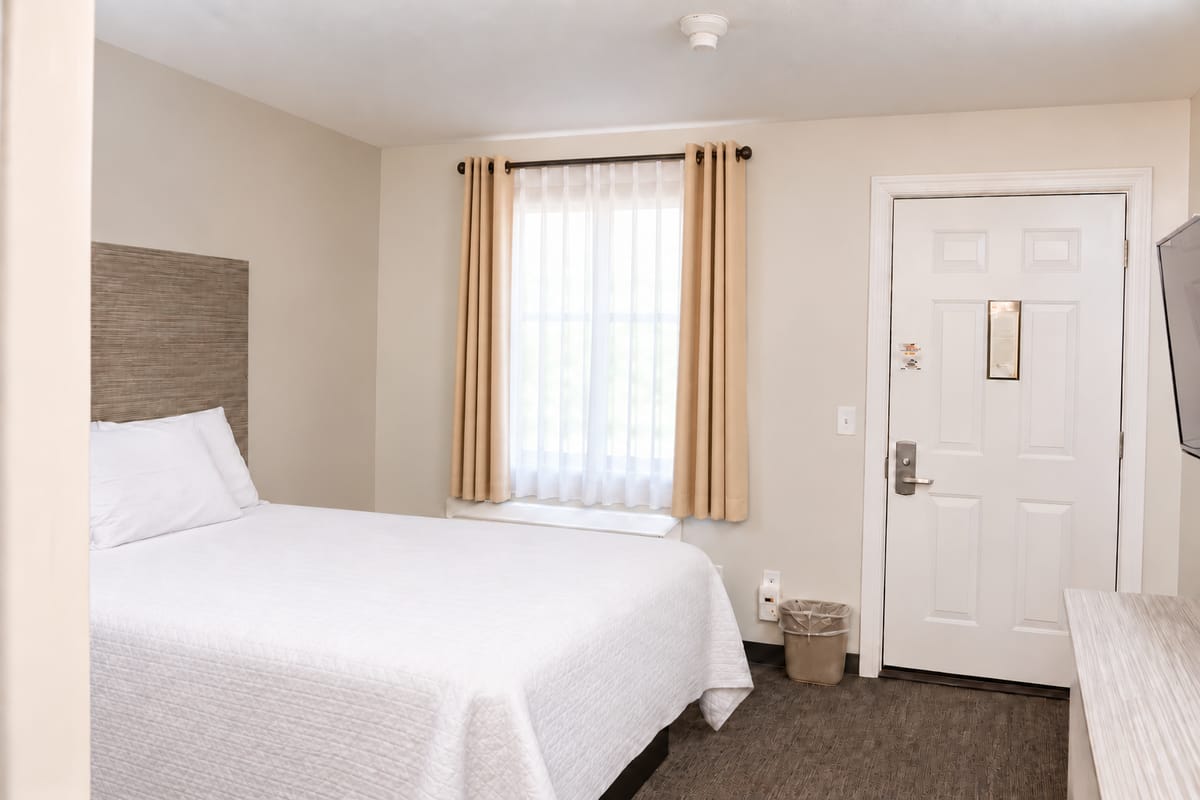Queen bed by the window in the Small Queen Room